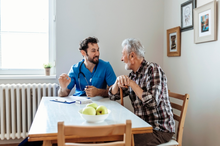Pinnacle Services Elder man sitting with male care taker at Bassett Creek